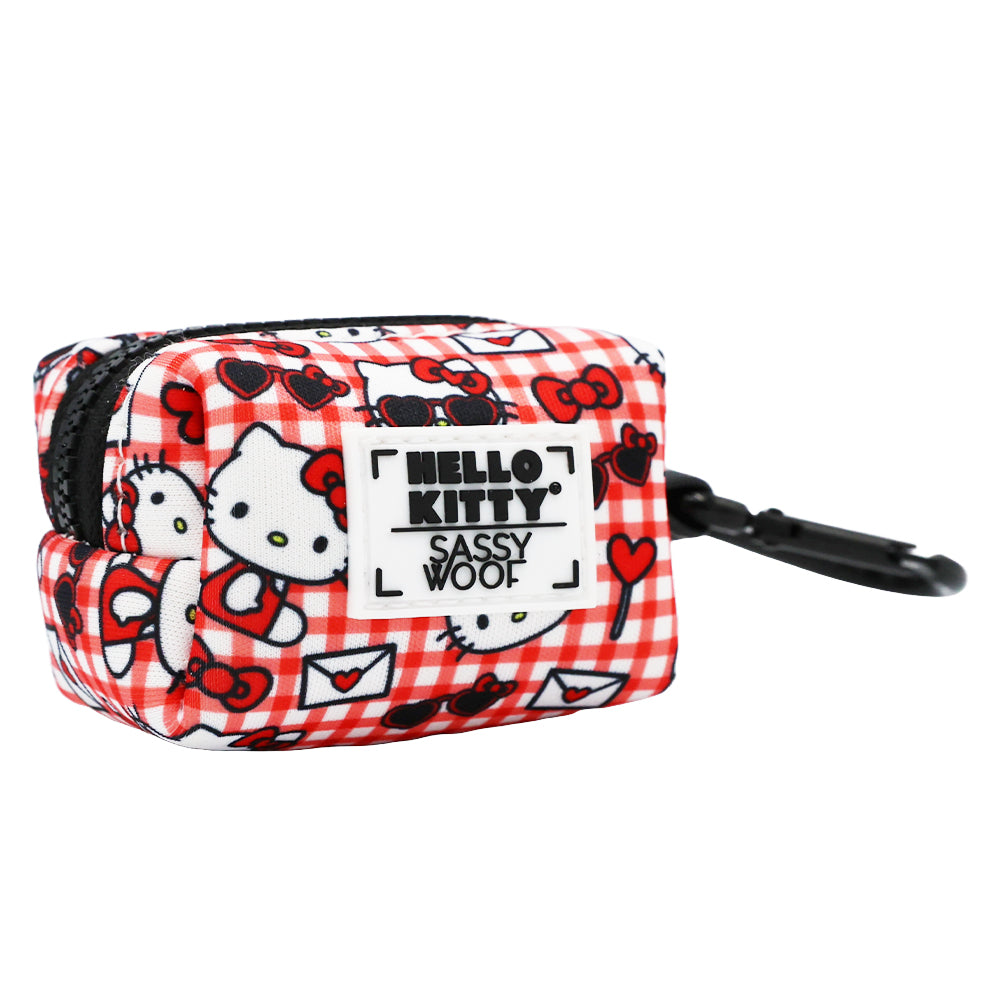 Red Hello Kitty pet waste bag holder by Sassy Woof, designed for convenient dog waste disposal, featuring a cute cartoon character.