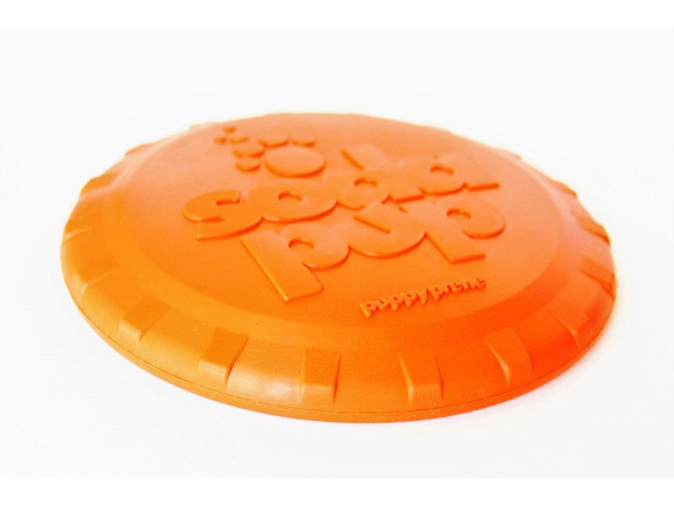 Orange rubber dog frisbee with bottle top design, vet approved SodaPup toy perfect for fetching and outdoor play.