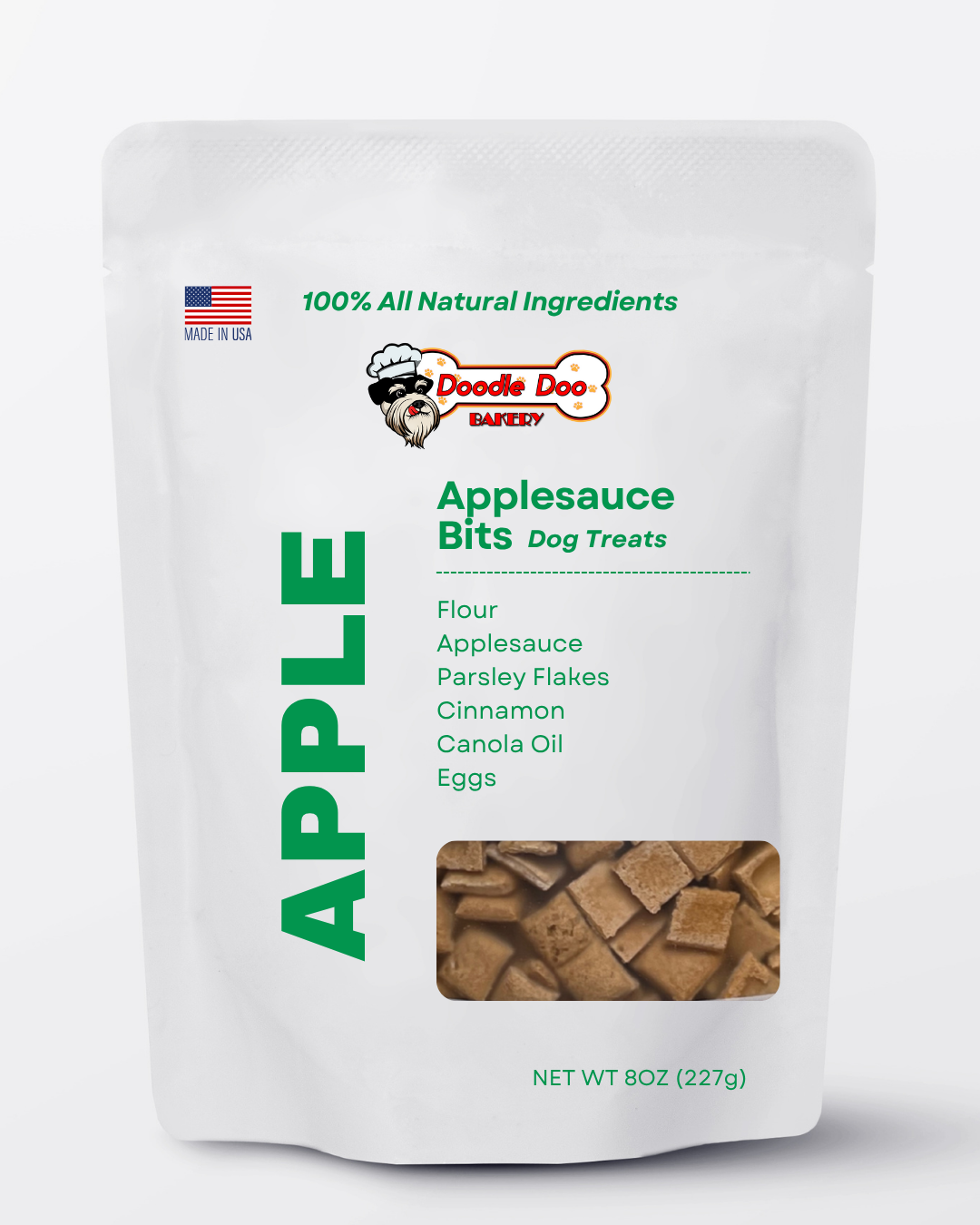 Homemade Doodle Doo Bakery apple bits dog treats in a 1/2 lb. bag, showing crunchy apple-flavored biscuits for dogs.