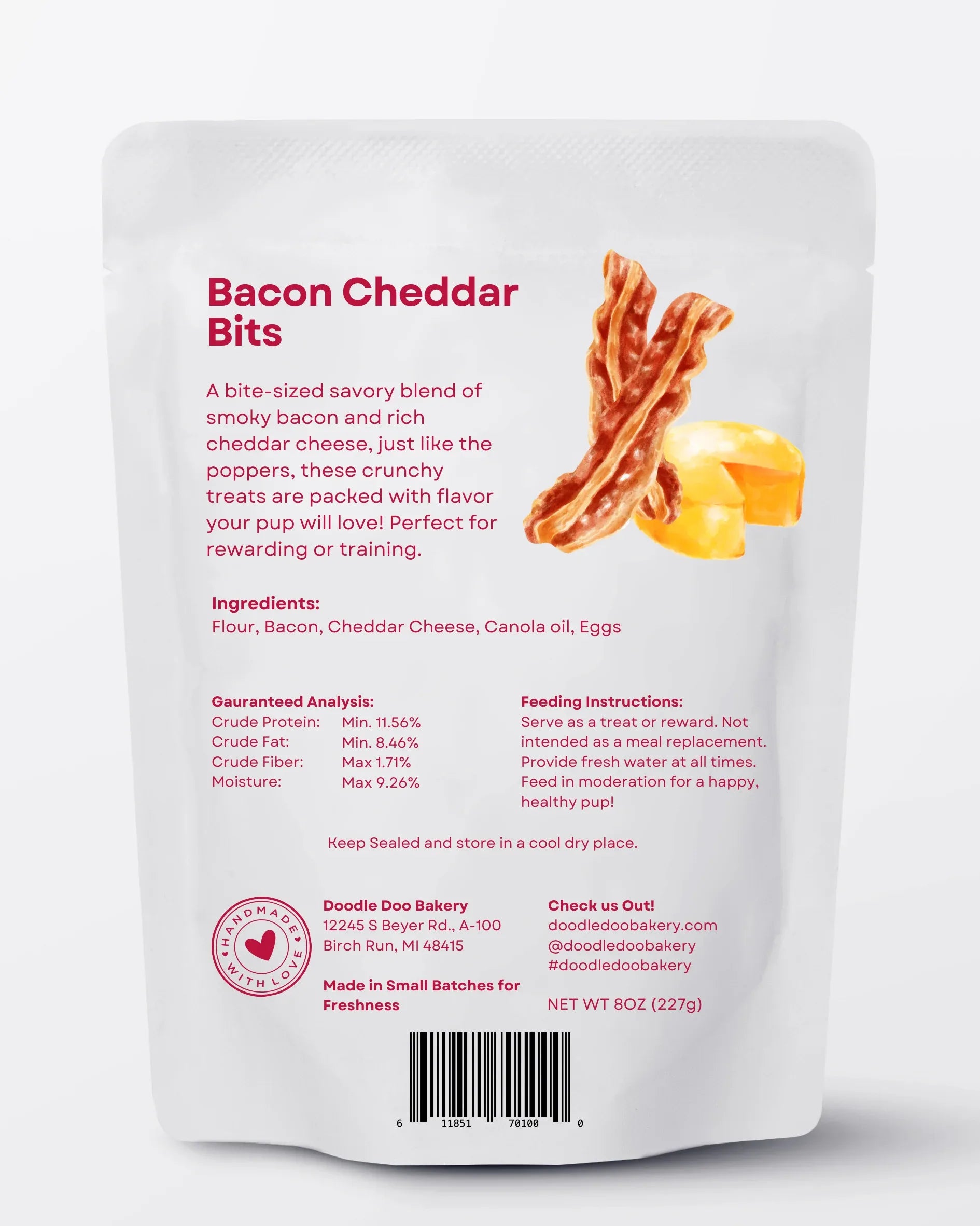 Homemade Doodle Doo Bakery bacon cheddar bits dog treats in a clear container, showing crunchy bacon and cheddar flavor.