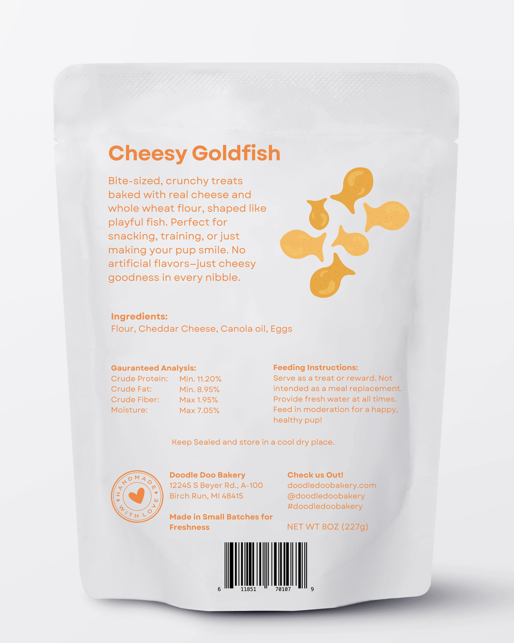 Homemade Doodle Doo Bakery cheesy Goldfish dog treats in a half-pound bag, showing golden fish-shaped treats for dogs.