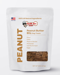 Homemade Doodle Doo Bakery peanut butter bits dog treats in a 1/2lb bag, showing crunchy dog biscuits with peanut butter flavor.