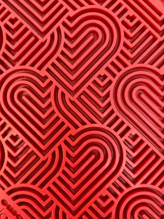 Love eMat enrichment lick mat for dogs and cats with a heart design, made by SodaPup, featuring a flexible silicone surface.